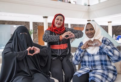 Dalal Abu Hamam, centre, with Nesreen Hassan, left, and Fadwa Hussein at the Friends of Cancer Patients in Sharjah.  Leslie Pableo for The National