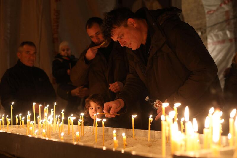 People light candles during a gathering to commemorate Kosovo Serb leader Oliver Ivanovic, in Saint Sava church in Belgrade, Serbia, January 16, 2018. REUTERS/Igor Pavicevic NO RESALES. NO ARCHIVES