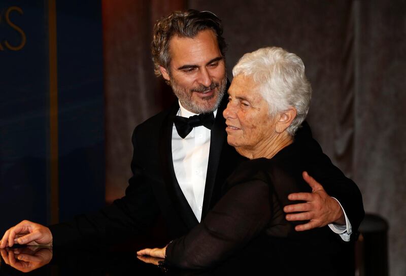 Best Actor Joaquin Phoenix embraces his mother Arlyn Phoenix as his Best Actor award is engraved at the Governors Ball after the Oscars on Sunday, February 9, 2020, at the Dolby Theatre in Los Angeles. Reuters