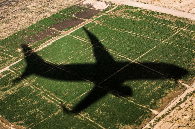 The shadow of an aircraft looms over a field as it approaches to land at Luxor International Airport, on the eastern outskirts of Egypt's southern city of Luxor. AFP