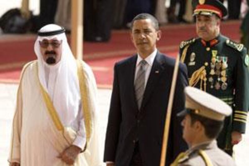 The US president Barack Obama (centre) is welcomed to the Kingdom of Saudi Arabia by King Abdullah (left) at King Khalid International Airport in Riyadh.
