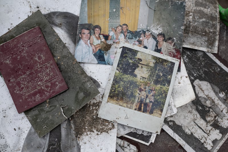 Photos of people are seen next to a destroyed apartment building on April 9 in Borodianka. Getty Images