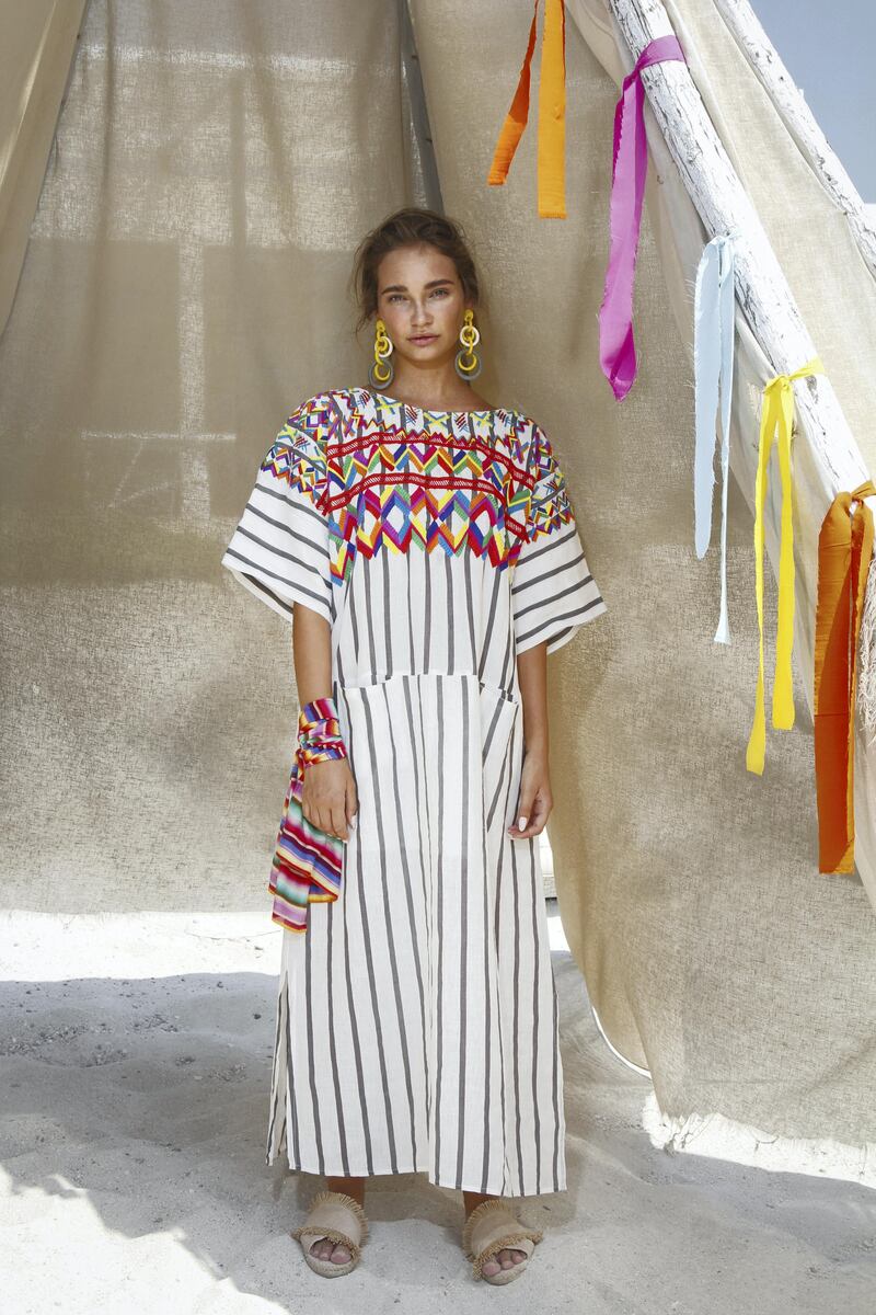 The yolk of this loose, kaftan-style dress is filled with embroidered embellishments