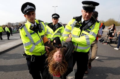 Police officers detain a climate change activist at Waterloo Bridge during the Extinction Rebellion protest in London, Britain April 18, 2019. REUTERS/Peter Nicholls