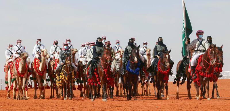 Saudi camel owners and horsewomen take part in a parade during the sixth edition of the King Abdulaziz Camel Festival in Remah, about 160 kilometres east of Riyadh. The festival introduced a round for female cameleers, allowing them, for the first time, to present their animals in a camel beauty contest. AFP