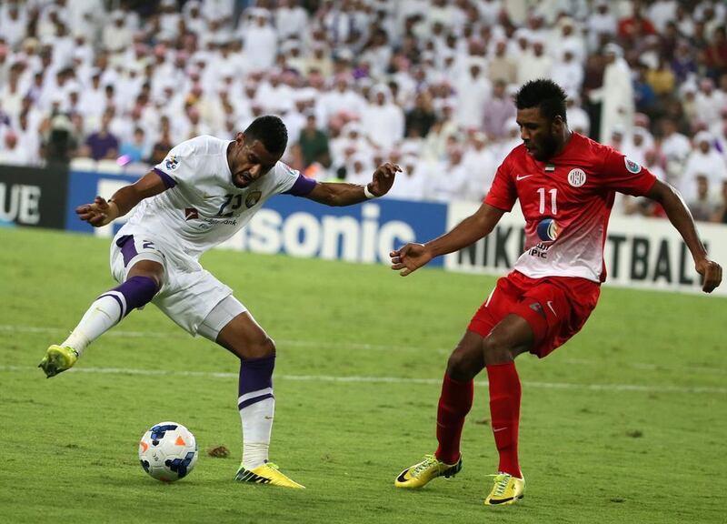 Al Ain's Mohamed Ahmad dribbles past Al Jazira's Jucilei da Silva during Tuesday night's Asian Champions League match. Karim Sahib / AFP / May 13, 2014