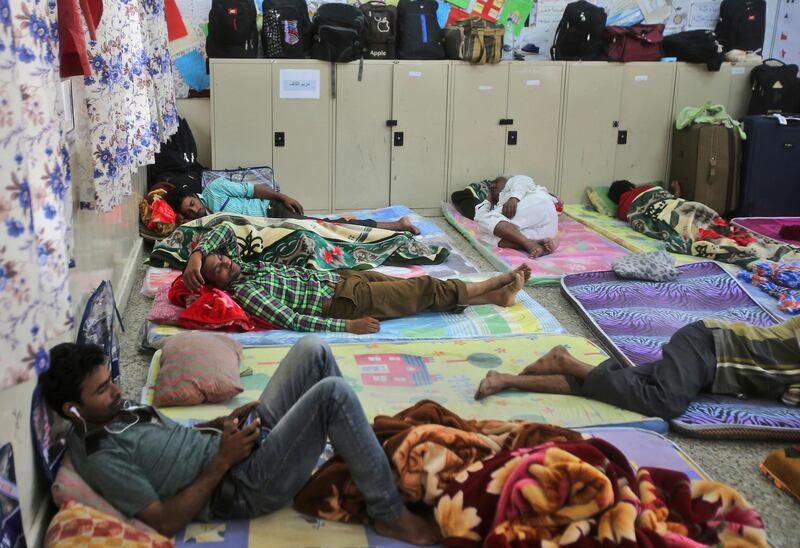 Workers rest ahead of Cyclone Mekuna's arrival on the mainland Arabian Peninsula. Kamran Jebreili / AP Photo