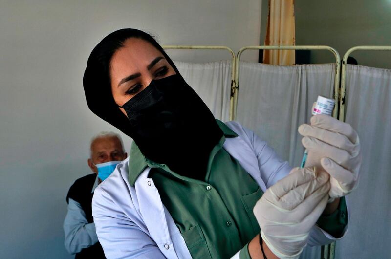 An Iraqi nurse prepares a shot of the AstraZeneca COVID-19 vaccine at a clinic in Baghdad, Iraq, Sunday, March 28, 2021. (AP Photo/Khalid Mohammed)