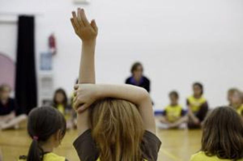 Madeline Peacock, seven, waits to ask a question during a Brownies meeting in Abu Dhabi.