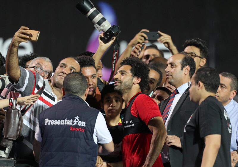 People take photos with Mohamed Salah. Mohamed Abd El Ghany / Reuters