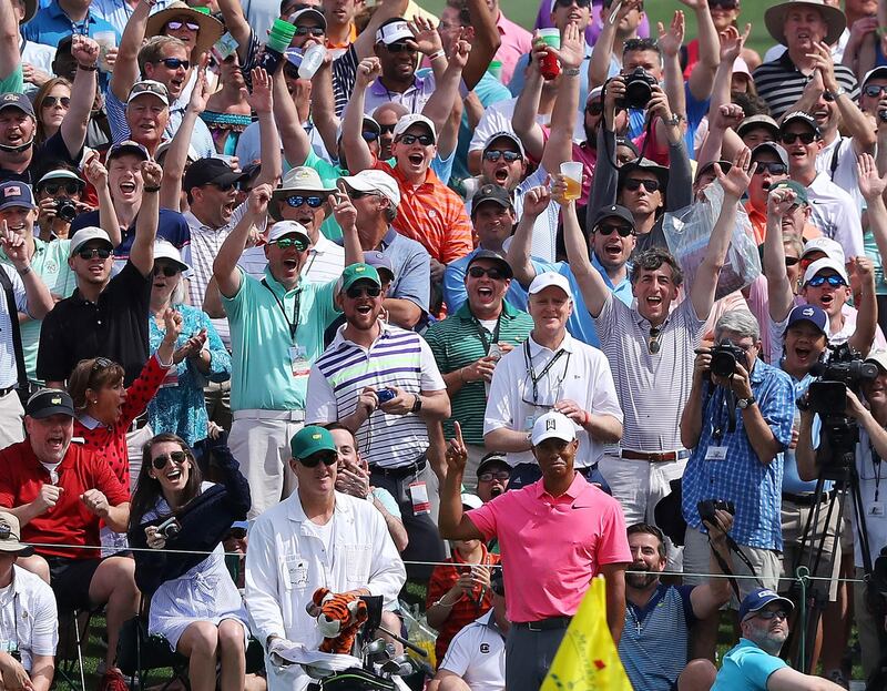 The massive gallery following Tiger Woods reacts as he chips in for an eagle on the second hole during practice for the Masters golf tournament at Augusta National Golf Club, Monday, April 2, 2018, in Augusta, Ga.  (Curtis Compton/Atlanta Journal-Constitution via AP)