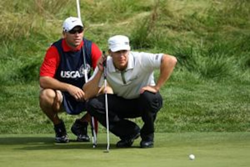 Ricky Barnes, right, lines up his putt on the seventh hole during the second round of the US Open on Saturday.