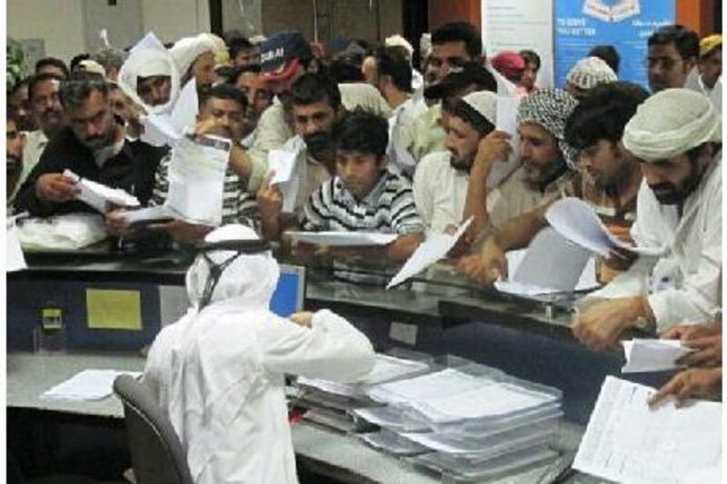 The Daman office in Al Ain is packed with people as thousands rush to avoid fines for failing to have valid health insurance.Essam Al Ghalib / The National