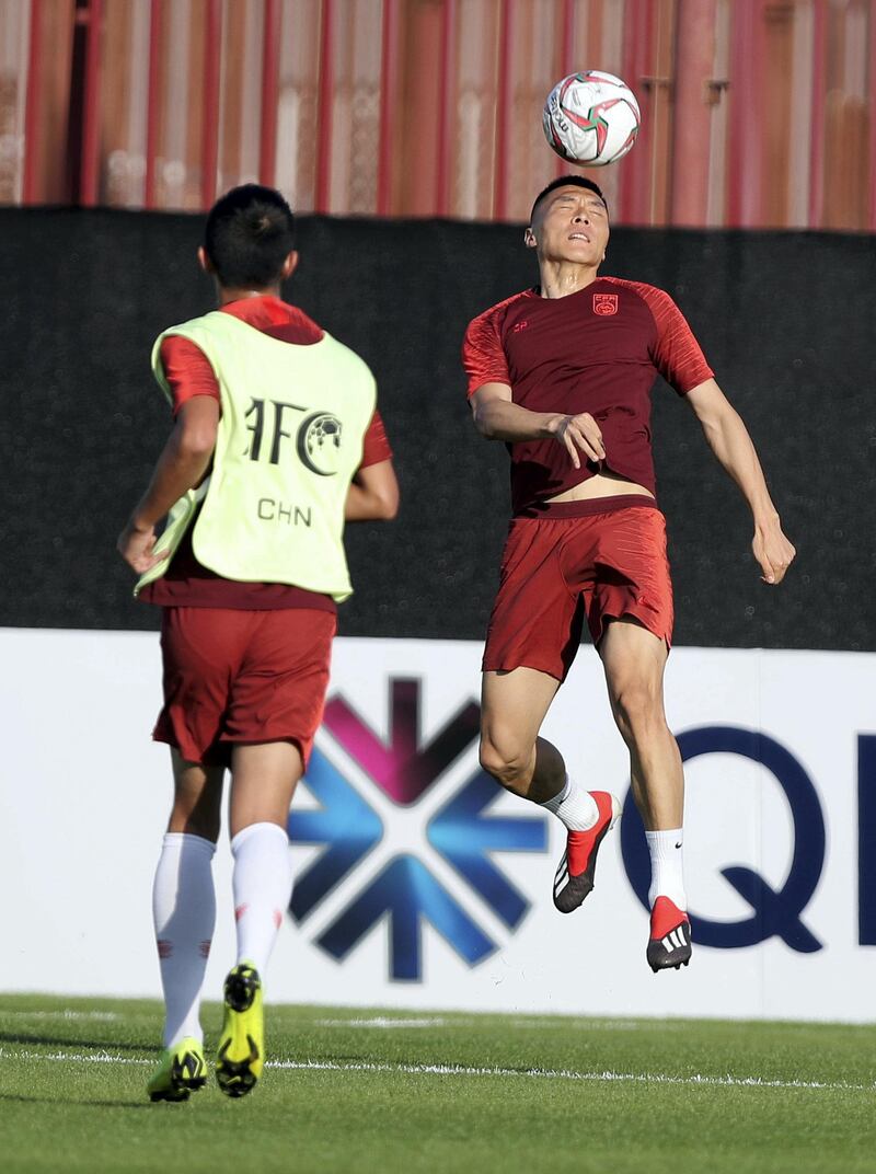 Abu Dhabi, United Arab Emirates - January 03, 2019: Yu Dabao (R) of China trains before the start of the Asian Cup 2019. Thursday, January 3rd, 2019 in Al Wahda Academy, Abu Dhabi. Chris Whiteoak/The National