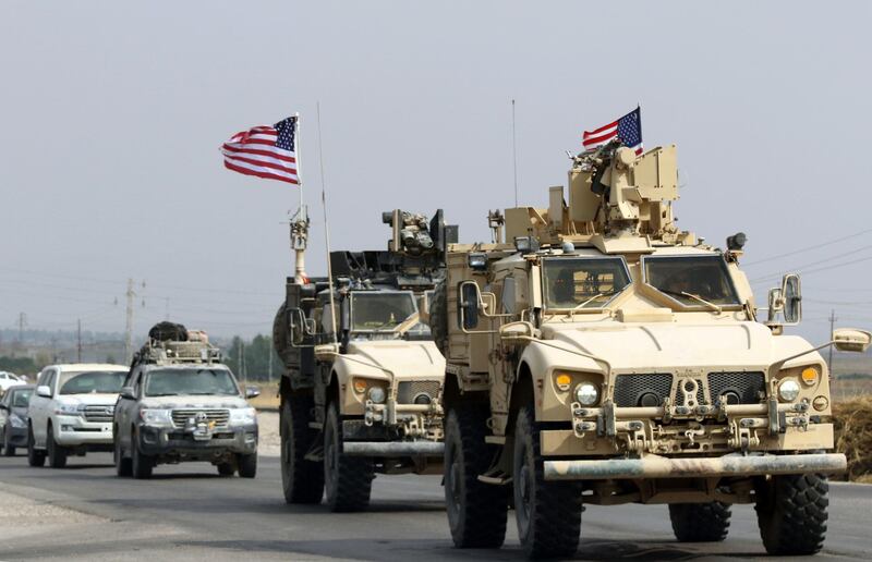 A convoy of US military vehicles arrives near the Iraqi Kurdish town of Bardarash in the Dohuk governorate after withdrawing from northern Syria on October 21, 2019.  / AFP / SAFIN HAMED
