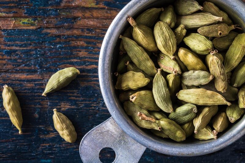 Close-Up Of Cardamom In Container On Table. Getty Images