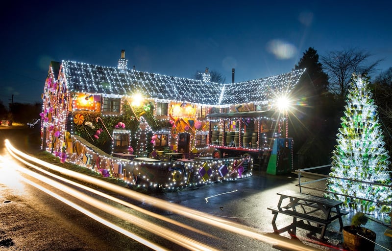 Lights illuminate the Queen Victoria Inn in the village of Priddy in Somerset, England. Renamed The Gingerbread Inn, which now features giant candy canes, sherbet, lollipops, liquorice allsorts, gingerbread men and a giant Christmas tree made out of recycled bottles. Matt Cardy / Getty Images