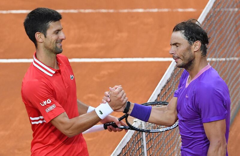epa09205205 Rafael Nadal (R) of Spain is congratulated by Novak Djokovic (L) of Serbia after winning their men's singles final at the Italian Open tennis tournament in Rome, Italy, 16 May 2021.  EPA/ETTORE FERRARI