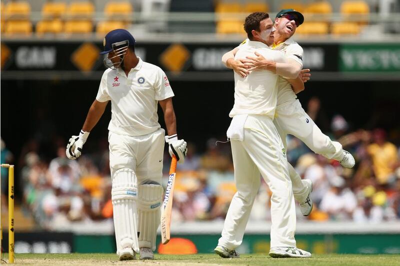 Josh Hazlewood, right, of Australia celebrates with teammate David Warner after dismissing MS Dhoni of India for LBW during Day 4 of the seond Test match at The Gabba on December 20, 2014 in Brisbane, Australia. (Photo by Cameron Spencer/Getty Images)