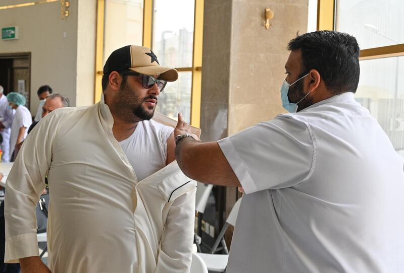 epa09146921 A man receives a dose of an anti Covid19 vaccine in Kuwait, Kuwait city, 20 April 2021. Kuwait will extend its partial curfew until the end of Ramadan, its parliament said on 19 April. The restrictions, put in place to curb the spread of Covid-19, are in effect from 7pm to 5 am.  EPA/Noufal Ibrahim