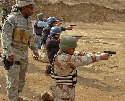 A US military instructor oversees firearms training for Iraqi police personnel in Mosul, northern Iraq. Photo: US Army