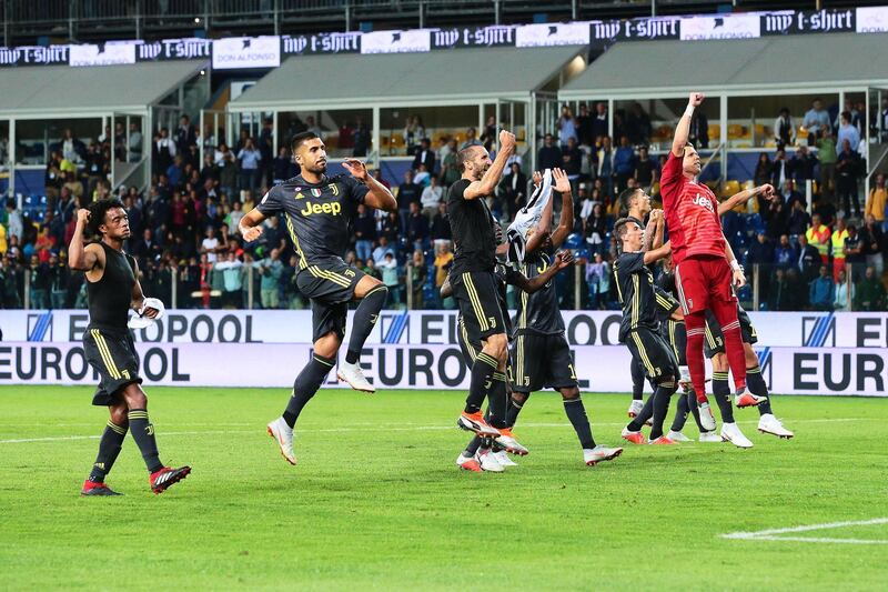 Juventus players celebrate in front of their fans after beating Parma.  EPA