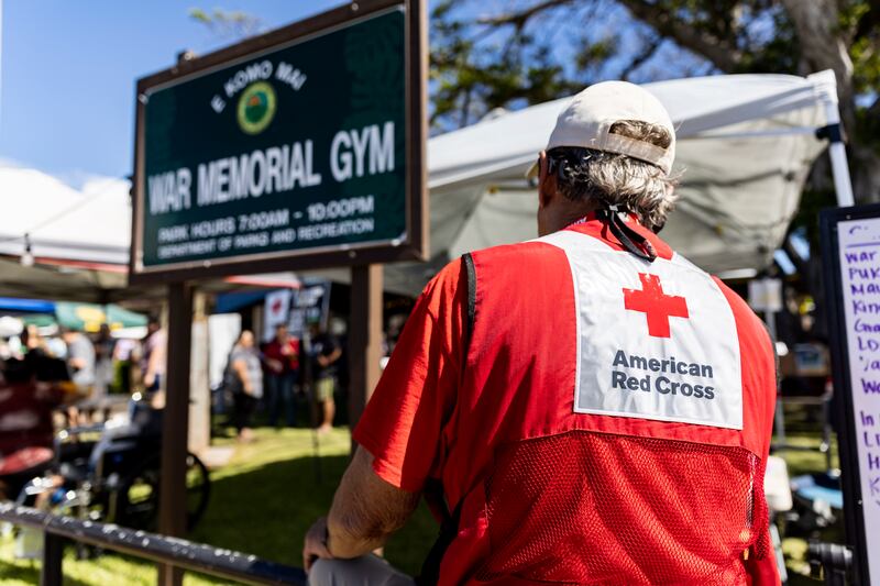 An American Red Cross worker stands at the entrance of the War Memorial Stadium, which is being used as a shelter for displaced Lahaina inhabitants in Kahului. EPA