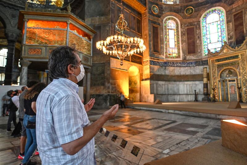 A Turkish visitor prays in front of the Apsis, facing the eastern direction of Hagia Sophia, in Istanbul. Turkey’s top administrative court on Friday announced its decision to revoke the 1,500-year-old former cathedral’s status as a museum.   AFP