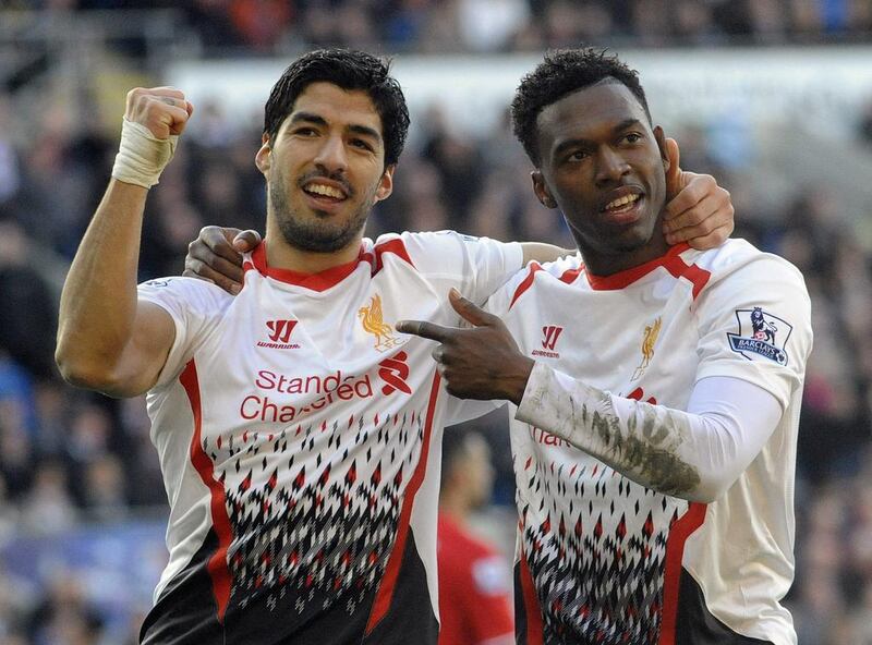 Liverpool's Daniel Sturridge, right, celebrates scoring a goal with Luis Suarez during their English Premier League match against Cardiff City in Cardiff, Wales, March 22, 2014. Rebecca Naden / Reuters