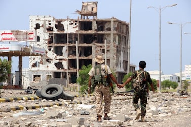 Members of Houthi militia pass a destroyed building during the deployment of observers on cross-lines in Hodeidah, Yemen, 19 October 2019. EPA