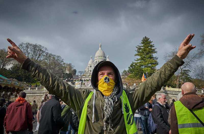 Yellow vest protesters chant slogans against President Macron and his government in front of Sacre Coeur in Paris in March 2019.
