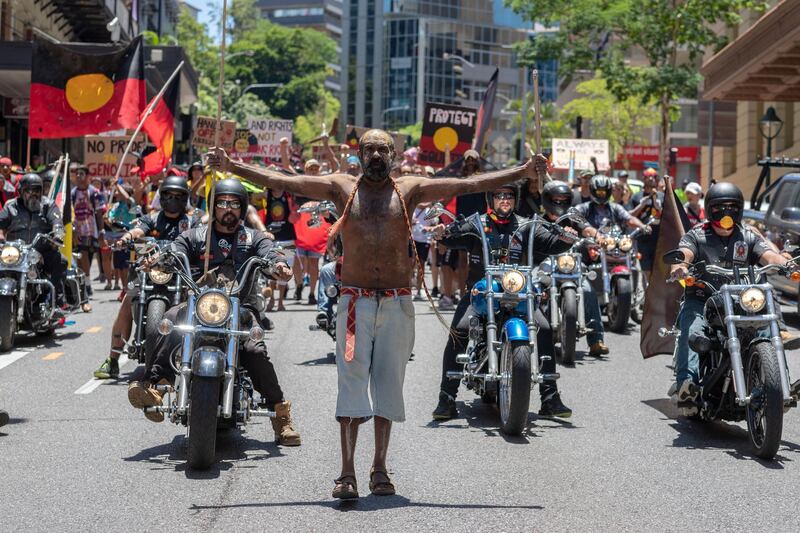 Protesters march down a street during Australia Day in Brisbane. EPA
