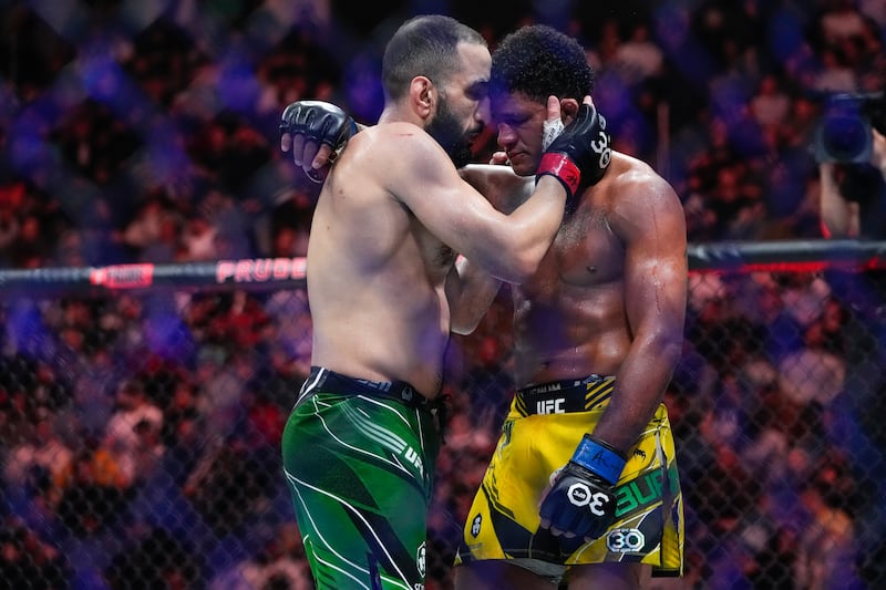 Belal Muhammad embraces Gilbert Burns after their welterweight bout at UFC 288 in New Jersey, USA on Sunday, May 7, 2023. AP