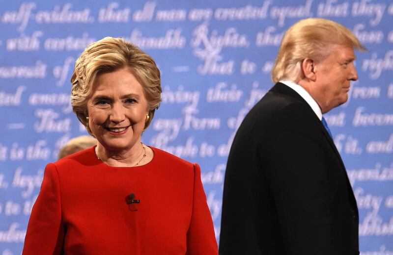 Democratic nominee Hillary Clinton (L) and Republican nominee Donald Trump leave the stage after the first presidential debate at Hofstra University in Hempstead, New York on September 26, 2016. (Photo by Timothy A. CLARY / AFP)