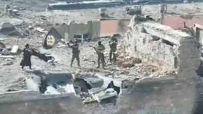 A still image taken from video apparently shows Wagner fighters on top of a building in Bakhmut. Reuters