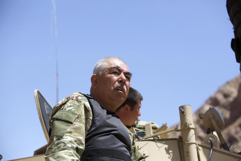 SHEBERGHAN, AFGHANISTAN - AUGUST 28 :  Afghan vice-president Abdul Rashid Dostum is seen on a military armoured wehicle during a military landing in Sar-e Pol province of Afhanistan on August 28, 2015, as part of the operations which have been launched agaisnt Daesh for about a month in Afganistan. Thousands of policemen and soldiers take part in the Afghan army convoy comprising hundreds of military wehicles helicoptes, departing from city of Sheberghan in Northen Afghanistan. (Photo by Mustafa Bag/Anadolu Agency/Getty Images)