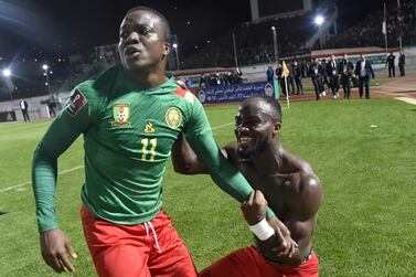 Cameroon's defender Nouhou Tolo (L) celebrates with teammate after qualifying for the 2022 Qatar World Cup African Qualifiers football match between Algeria and Cameroon at the Mustapha Tchaker Stadium in the city of Blida on March 29, 2022.  (Photo by AFP)