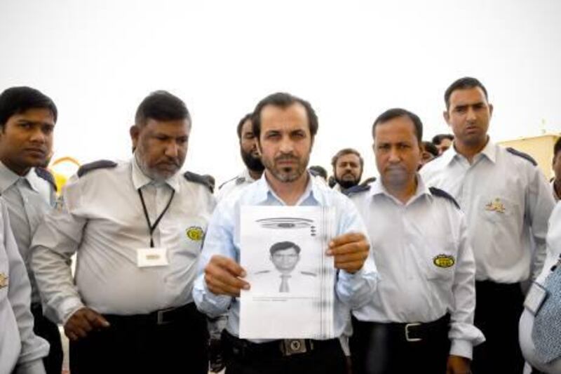 June 12, 2011, Al Ain, UAE:

Taxi drivers in Al Ain staged a protest today after one of their colleagues, Mohammed Enamulhaq, was found brutally murdered in his taxi yesterday. 

Cab drivers hold up a xerox of a photo of their fallen colleague.
Essam al Ghalib/The National