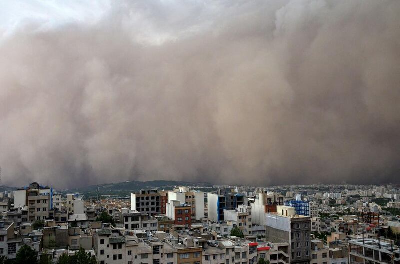 A picture taken shows a sandstorm engulfing the northeastern neighbourhood of Minicity in the Iranian capital Tehran. A massive sandstorm and record winds killed at least four people in Tehran, plunging the city into darkness, knocking out power supplies, damaging buildings and causing massive disruption. Sadeeh Eslamieh / AFP