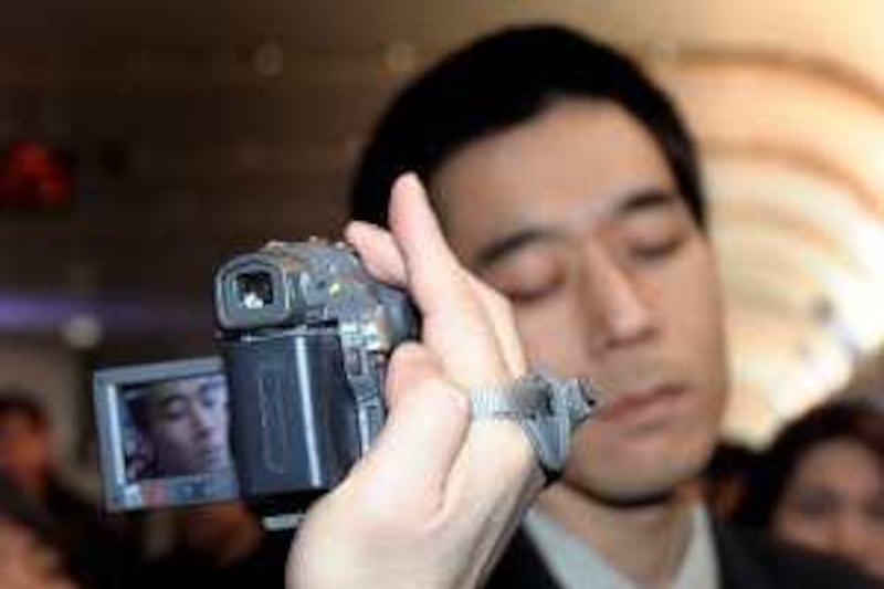 A journalist uses a camcorder to capture American missionary Robert Park upon his arrival at the Beijing Capital Airport, Saturday, Feb. 6, 2010. (AP Photo/Andy Wong) His arrival in Beijing came a day after North Korea announced it would free Robert Park. (AP Photo/Andy Wong)