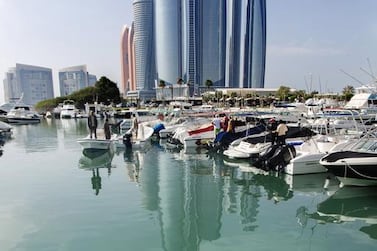 This four-metre-long whale shark drew onlookers at the marina near the InterContinental hotel in Abu Dhabi. Coastguards tried to redirect it to the exit. Irene García León for The National