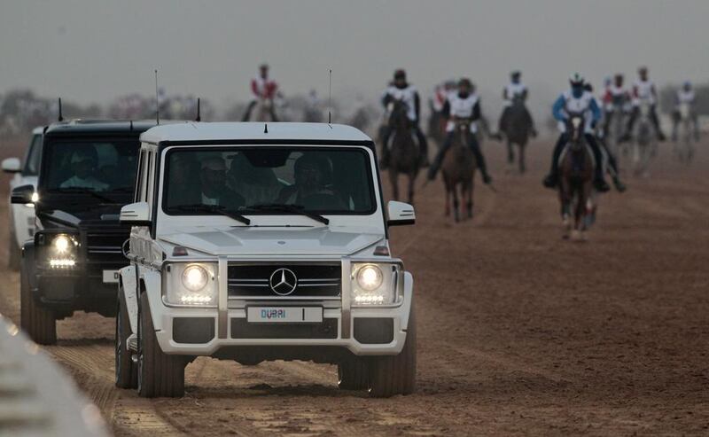  Sheikh Mohammed bin Rashid drives his car alongside the track during the race.