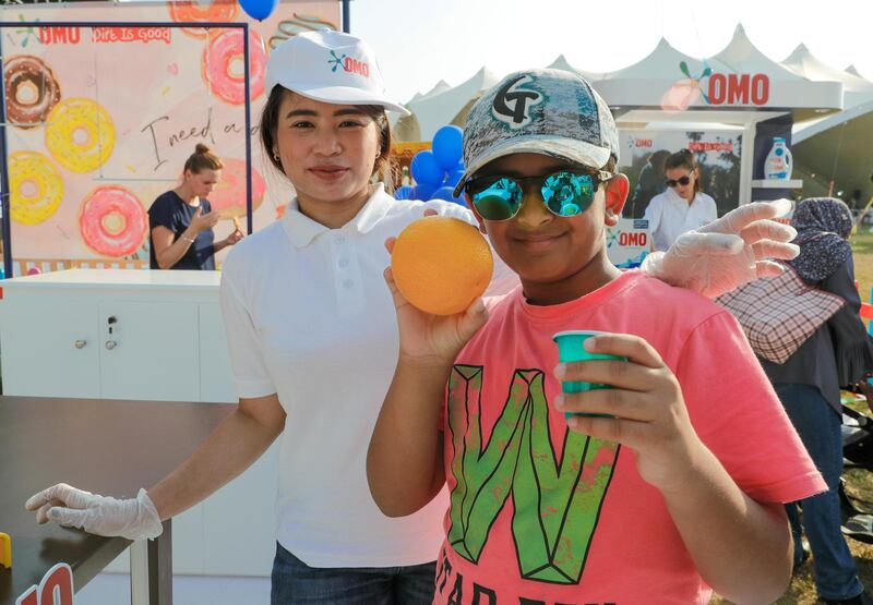 Abu Dhabi, United Arab Emirates, November 9, 2019.  
Taste of Abu Dhabi at the Du Arena.  
--Saif Al Hudarami proudly shows off his freshly squeezed orange juice with teacher, Carla Lacson.
Victor Besa/The National
Section:  NA
Reporter: