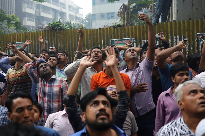 People react as they watch the rescue efforts. Reuters