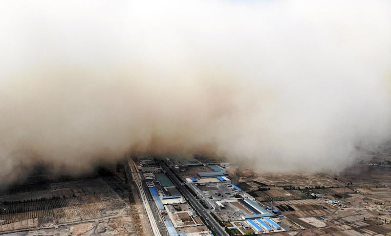 A sandstorm engulfing a village in Linze county, in the city of Zhangye in China's northwestern Gansu province. AFP