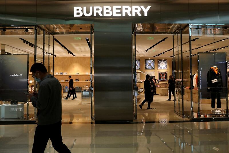 FILE PHOTO: A man walks past a store of luxury brand Burberry at a shopping mall in Beijing, China March 26, 2021. REUTERS/Tingshu Wang/File Photo