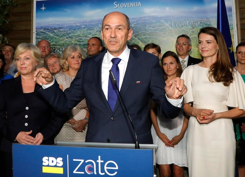 epa06783536 Janez Jansa (C), President of the SDS (Slovenian Democratic Party) and candidate for the snap parliamentary elections talks to the media after his party won, according to the initial polls result, in Ljubljana, Slovenia, 03 June 2018.  EPA/ANTONIO BAT