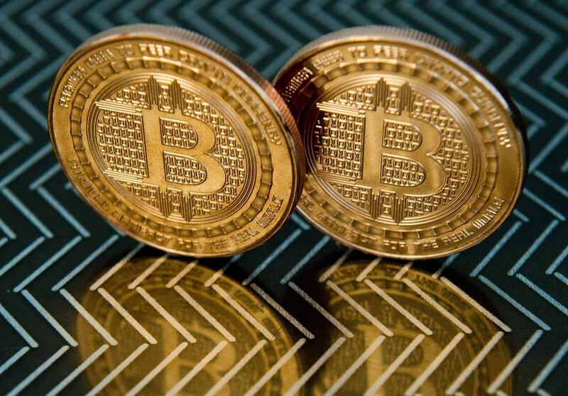(FILES) In this file photo taken on June 17, 2014 in Washington, DC shows bitcoin medals.  US authorities arrested three men in an alleged fraud that raised $722 million from investors lured by fake bitcoin mining earnings, the Justice Department announced on December 10, 2019. Prosecutors described the scam as a "high-tech Ponzi scheme" run by the "BitClub Network," which took money from investors and rewarded them for recruiting new shareholders. / AFP / KAREN BLEIER / TO GO WITH AFP STORY  - "Florida city agrees to pay $600,000 ransom to hackers"
