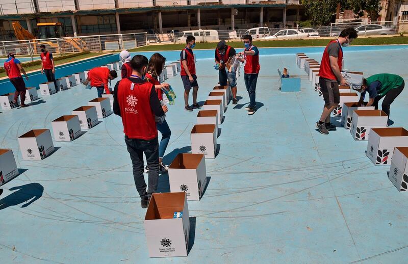 Algerian Food Bank volunteersprepare packages of food in Algiers. AFP