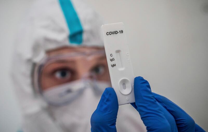 A medical worker performs a rapid antibody test during the Covid-19 pandemic in Berlin, Germany. AP Photo